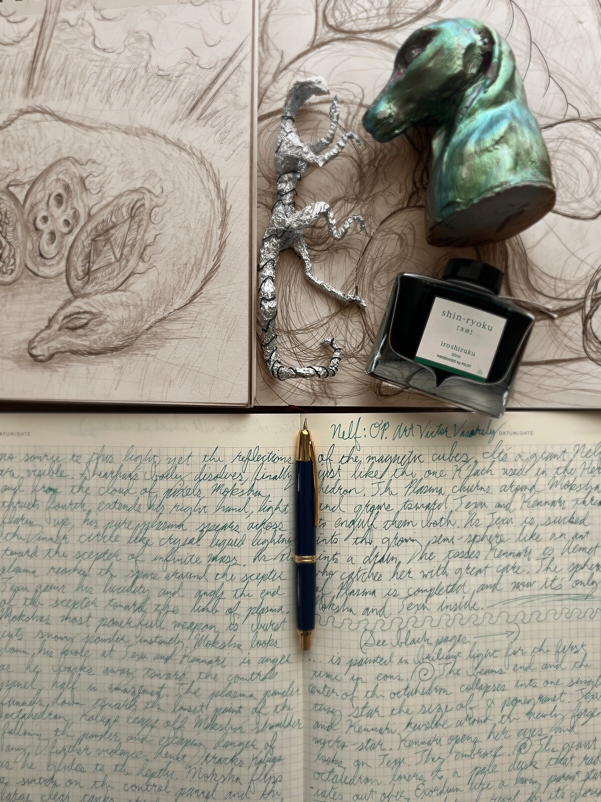 Sketchbook, sculpted maquette and fountain pen ink on the desk